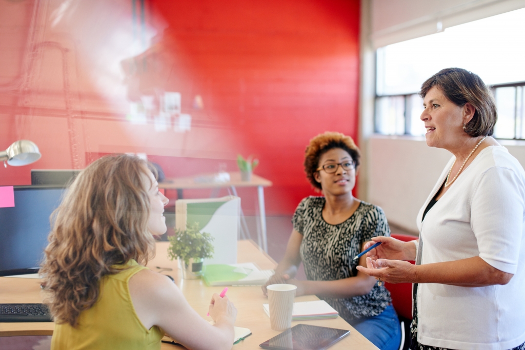 Group of creative business people in an open concept office brainstorming their next project.