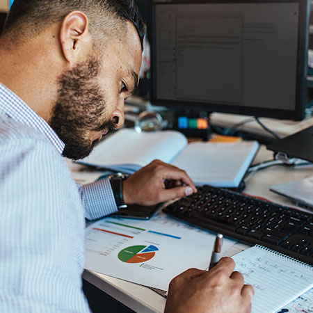 Businessman making notes at his office desk.