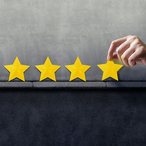 person places four stars on the wall